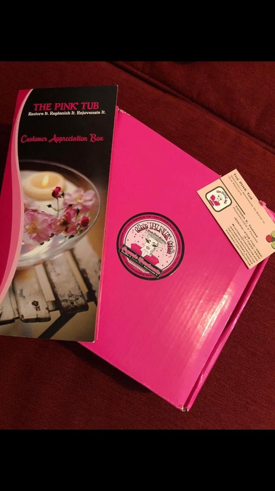A pink box with some food inside of it