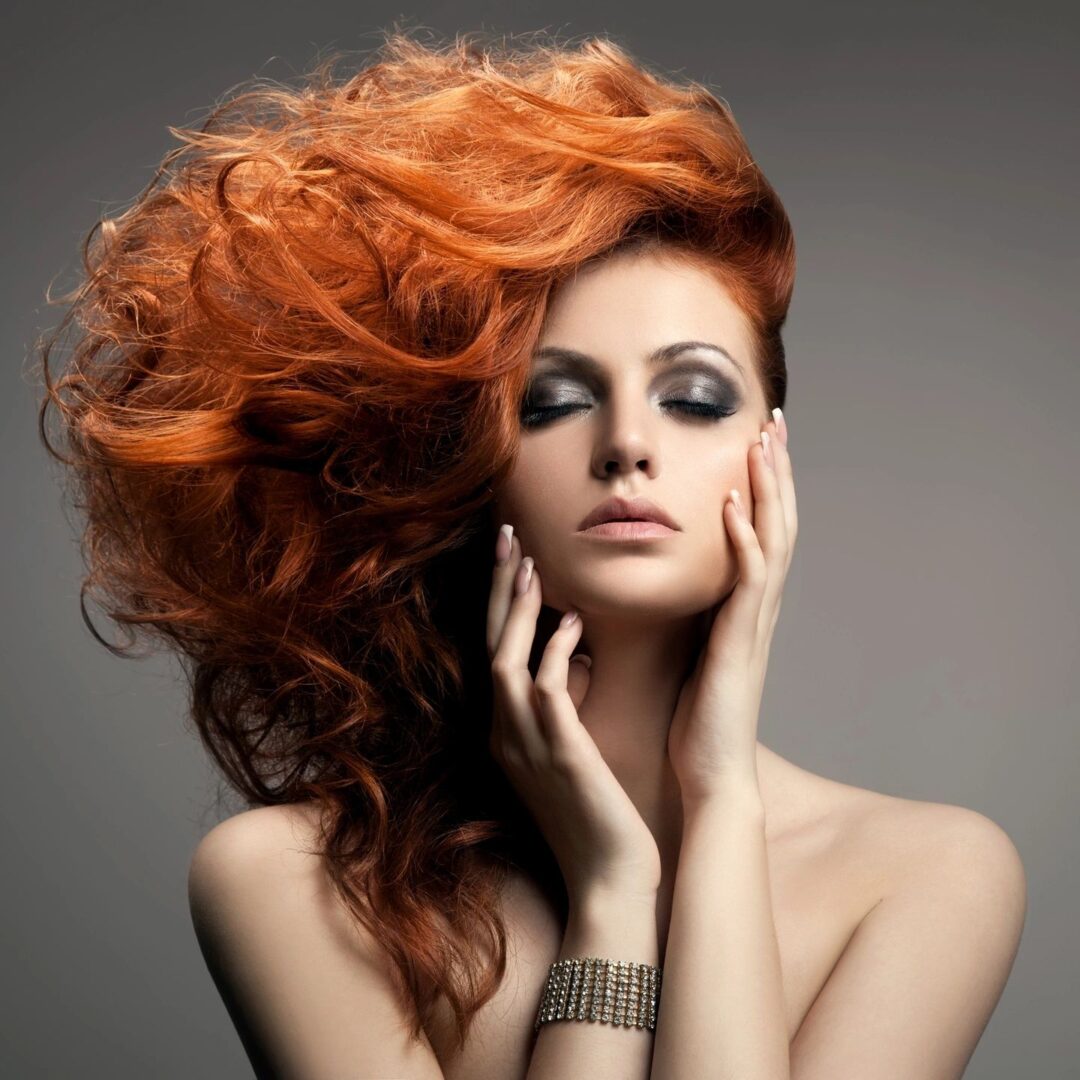 A woman with bright orange hair posing