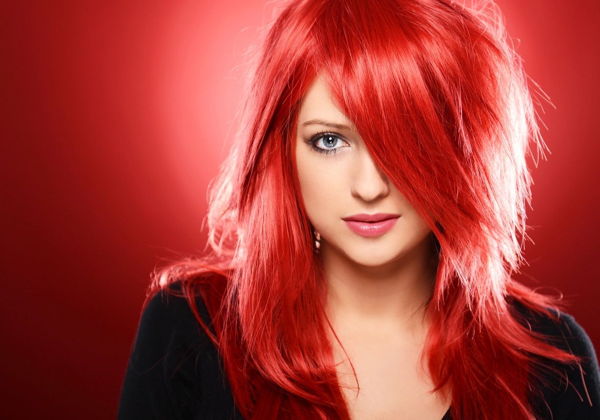 A woman with red hair and blue eyes.