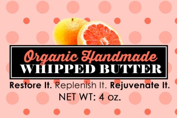 A pink polka dot background with an orange and grapefruit.