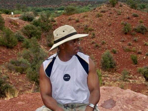 Candid image of a man wearing a hat amongst nature