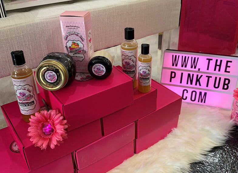 A pink display of products on top of red boxes.